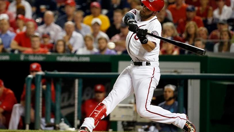 In this photo taken Aug. 27, 2015, Washington Nationals right fielder Bryce Harper (34) bats during a baseball game against the San Diego Padres at Nationals Park in Washington. As they try to forget about 2015 and get started on 2016 at spring training, the best news for the Washington Nationals is that unanimous NL MVP Bryce Harper is still around. (AP Photo/Alex Brandon)