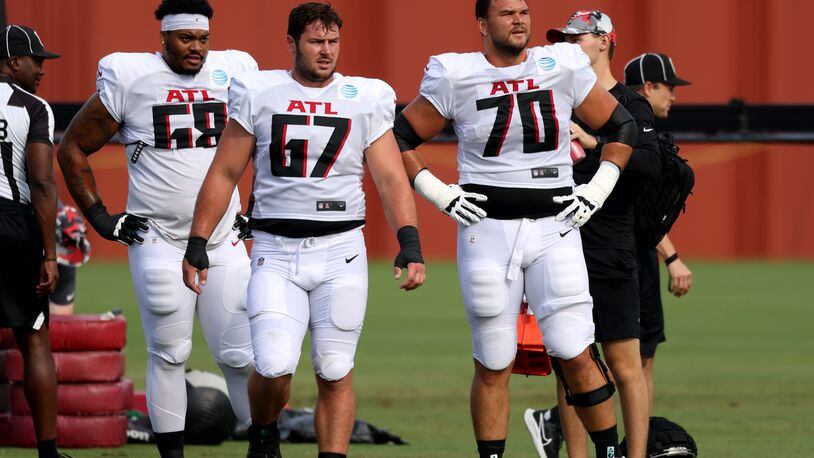 Falcons offensive lineman from left to right; Elijah Wilkinson (68), Drew Dalman (67), and Jake Matthews (70) take a breather during training camp at the Falcons Practice Facility, Tuesday, August 2, 2022, in Flowery Branch, Ga. (Jason Getz / Jason.Getz@ajc.com)