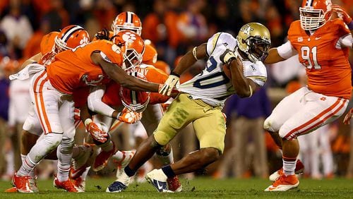CLEMSON, SC - NOVEMBER 14: Quandon Christian #34 of the Clemson Tigers grabs the jersey of David Sims #20 of the Georgia Tech Yellow Jackets during their game at Clemson Memorial Stadium on November 14, 2013 in Clemson, South Carolina. (Photo by Streeter Lecka/Getty Images)