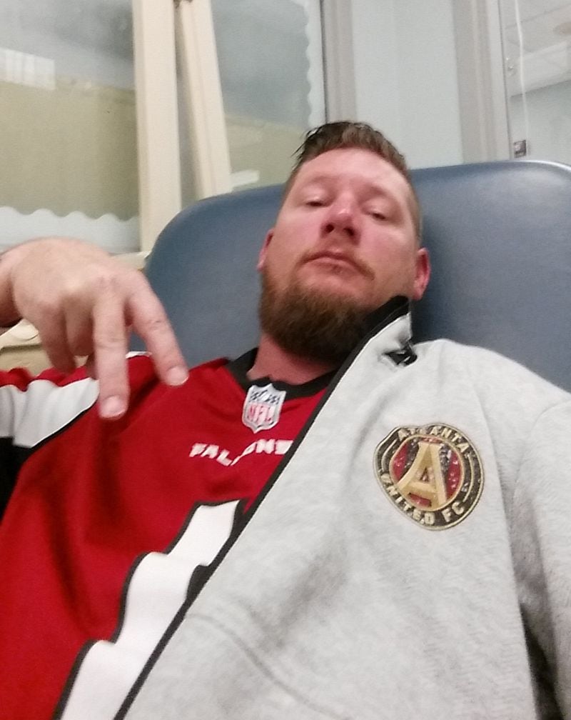 Atlanta United fan Josh Proctor "reppin the A" during his first round of chemotherapy in August. (Photo courtesy of Josh Proctor)