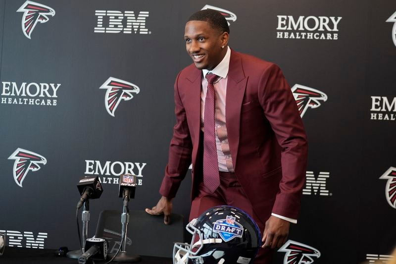 Atlanta Falcons first round draft choice quarterback Michael Penix Jr., takes his seat before speaking at a news conference Friday, April 26, 2024, in Flowery Branch, Ga. (AP Photo/John Bazemore)