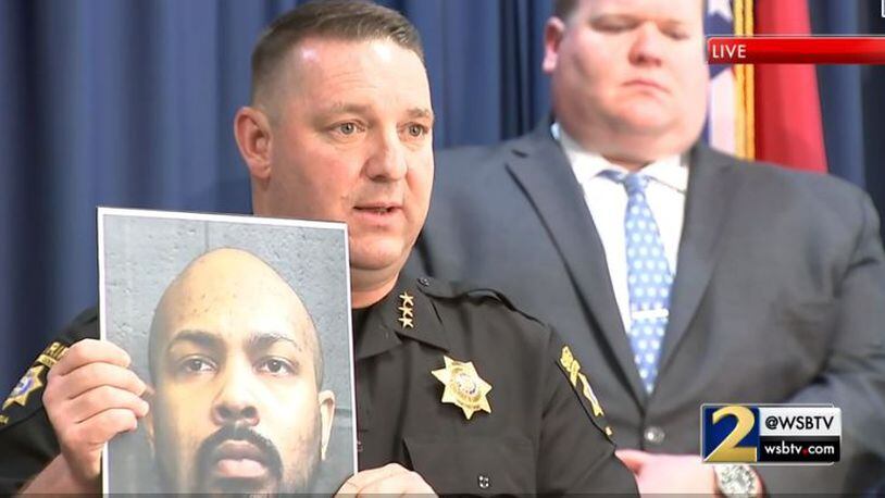 Forsyth County Sheriff Ron Freeman holds a photo of Kwame Abayomi during a news conference Tuesday. Abayomi, a Forsyth inmate, is accused of plotting with four others to kill the victim of a 2017 carjacking before he could testify against him.