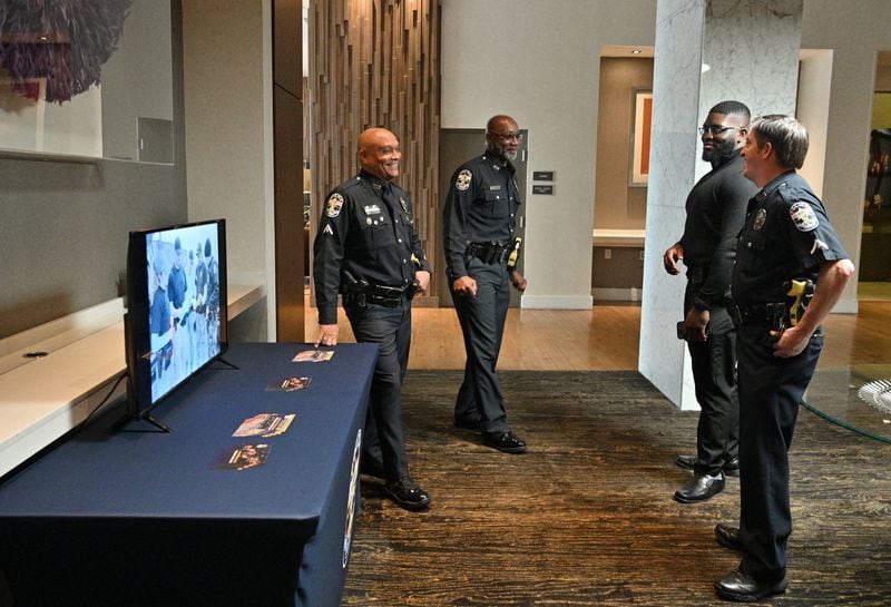 March 24, 2022 Atlanta - Recruiters from Louisville Metro Police mingle as they wait for potential recruits during their recruiting event at Hyatt Centric Midtown Atlanta on Thursday, March 24, 2022. (Hyosub Shin / Hyosub.Shin@ajc.com)