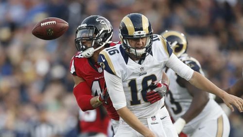 Falcons linebacker Vic Beasley Jr. strips the ball from Rams quarterback Jared Goff, subsequently returning the fumble for a third quarter touchdown at the Coliseum Sunday, Dec. 11, 2016 in Los Angeles. The Falcons won 42-14.  (Robert Gauthier/Los Angeles Times/TNS)