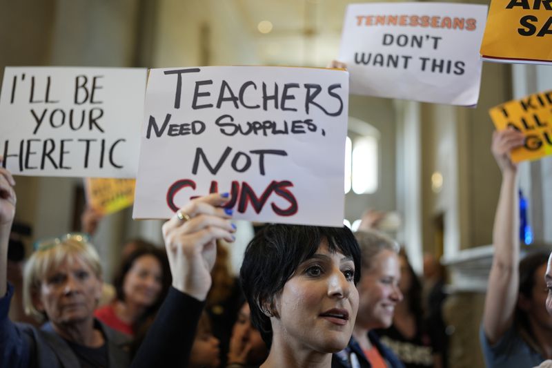 People protest outside the House chamber after legislation passed that would allow some teachers to be armed in schools during a legislative session Tuesday, April 23, 2024, in Nashville, Tenn. (AP Photo/George Walker IV)