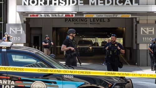 Law enforcement officers are seen on West Peachtree Street in front of the Northside Hospital Midtown medical office building, where five people were shot on May 3. One person died. (Arvin Temkar/The Atlanta Journal-Constitution)