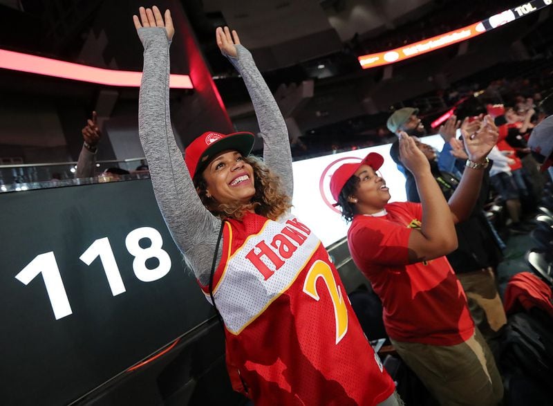 Jaye Oliver (from left) and Amanda Newton help lead the cheers in the 6th Man Section from Section 118 at Philips Arena. CURTIS COMPTON / CCOMPTON@AJC.COM