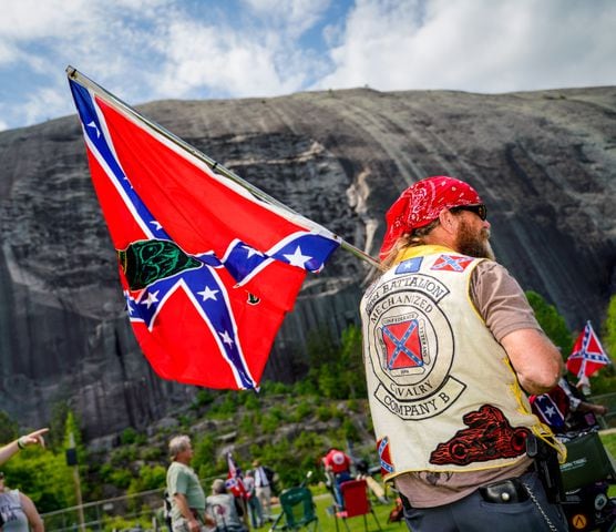 A man flies a Confederate flag at the base of Stone Mountain on Saturday morning, April 30, 2022, as the Sons of Confederate Veterans gathered at Stone Mountain Park. (Photo: Ben Hendren for The Atlanta Journal Constitution)