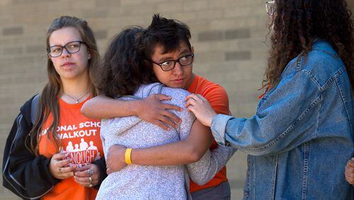Lakeside High School student Roni Wagner gives Leah Weiss a hug after Weiss gave an emotional speech during National Walkout day in Atlanta on Friday, April 20, 2018. STEVE SCHAEFER / SPECIAL TO THE AJC