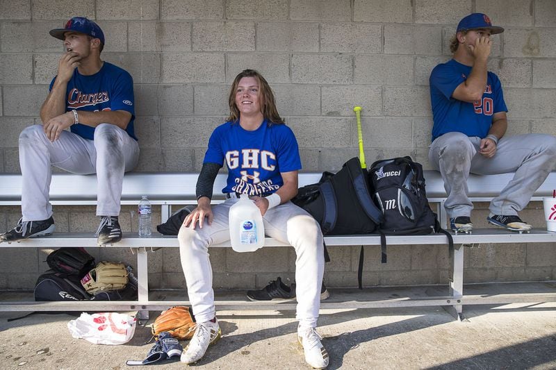 Georgia Highlands College freshman Ashton Lansdell (center) sits in the dugout with her teammates Trace Twardoski (left) and Jonathan Bergmoser (right) during a baseball intrasquad scrimmage at the Lakepoint Sports Complex in Emerson on Sept. 26, 2019. ALYSSA POINTER / ALYSSA.POINTER@AJC.COM