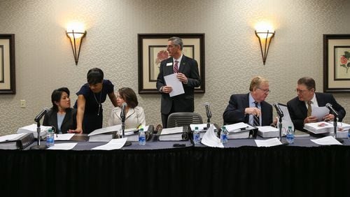 State Election Board members prepare for an emergency hearing held at the Georgia Center for Continuing Education in Athens on Wednesday, March 11, 2020. Secretary of State Brad Raffensperger is standing, surrounded by seated board members from left: Anh Le, Rebecca Sullivan, David Worley and Mathew Mashburn. (Photo/Austin Steele for The Atlanta Journal Constitution)