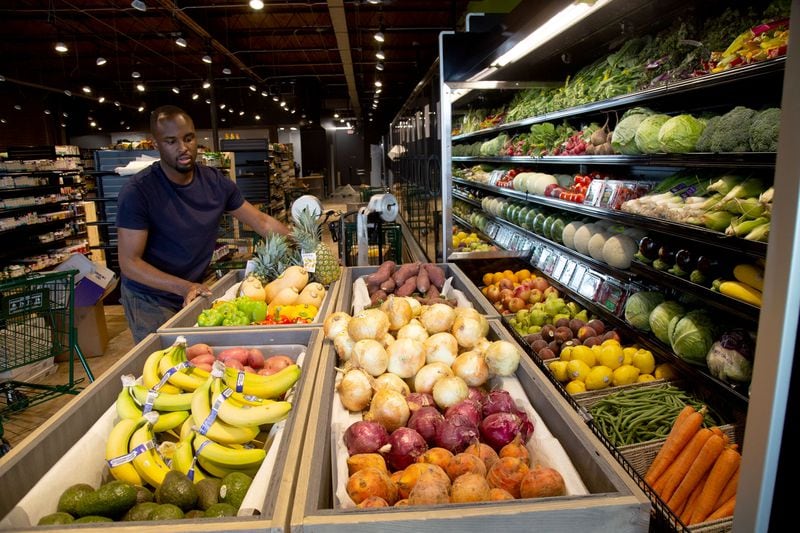 Karon Ford works on organizing the produce before the soft opening at the new Nuts 'n Berries in Decatur Tuesday, May 28, 2020. STEVE SCHAEFER FOR THE ATLANTA JOURNAL-CONSTITUTION