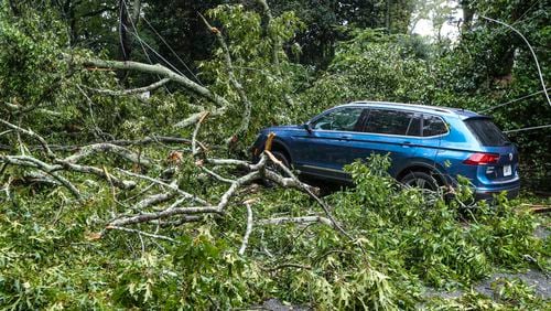 September 17, 2020 Atlanta: Atlanta Fire Rescue kept an apparatus on the scene where a tree brought wires down across Peachtree Battle at Havenridge Drive in Atlanta in Atlanta. Officials at the scene did not disclose the condition of the driver of the vehicle. Remnants of Hurricane Sally, that downgraded to a tropical depression, moved through North Georgia on Thursday, Sept. 17, 2020. Heavy rain and flooding brought trees down and made a mess of the Thursday morning commute and knocked out power to thousands. By mid-day, Fulton, DeKalb and Gwinnett counties received between 2 and 4 inches of rain, and the Southside, between 1 and 3 inches. Those areas could see as much as another 4 inches of rain before the end of the day, according to rain forecast.  (John Spink / John.Spink@ajc.com)

