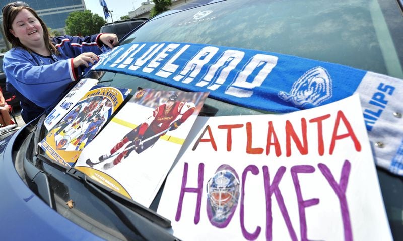 Atlanta Thrashers fan Jennifer Peters, of Suwanee, decorates her car with a banner and signs to show her support during a rally before the team's annual select-a-seat event for season-ticket holders at Philips Arena in Atlanta on Saturday, May 21, 2011. The Thrasher fan club is staging an impromptu save-the-team rally amid reports of the team's sale and relocation to Canada. Hyosub Shin, hshin@ajc.com