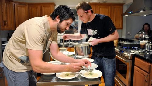 Hidinger (left) and Ben Barth (right) prepare fennel soup with apple relish at the supper club the Hidingers hosted in their Grant Park home in 2010.