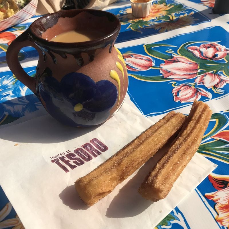 Taquería el Tesoro doubles as a neighborhood coffee shop that serves beverages such as café de olla (pictured), drip coffee fragrant with clove, star anise, cinnamon and orange and served in a painted clay mug, as well as baked goods and pastries, including churros. LIGAYA FIGUERAS / LFIGUERAS@AJC.COM