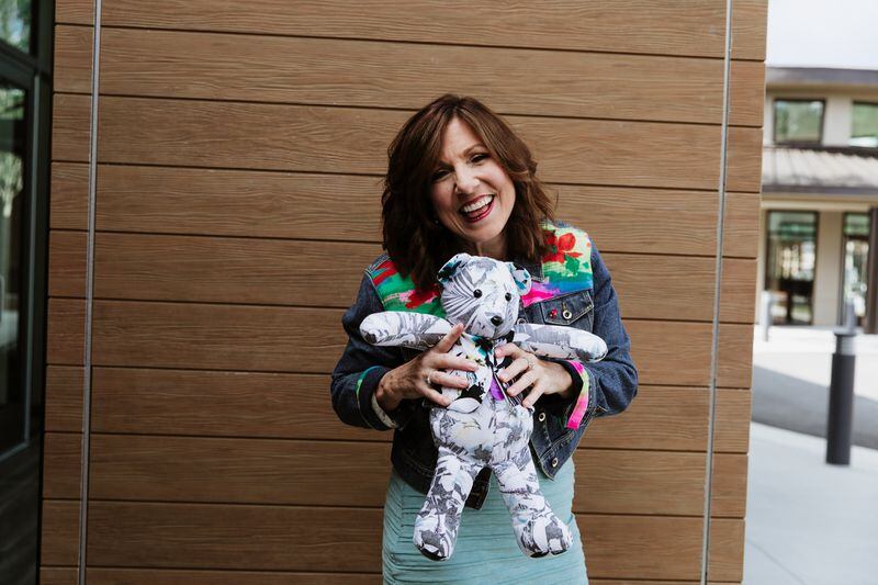 Kathy Mullen holding a stuffed bear made out of her son's favorite shirt.