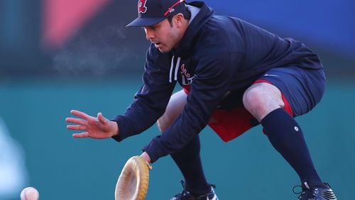 Braves utility man Chase d’Arnaud, shown using an undersized glove during a spring-training fielding drill, could be an option as a backup first baseman. He got his first work at the position Saturday. (Curtis Compton/ccompton@ajc.com)