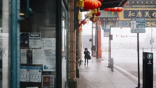A person walks in Chicago’s Chinatown neighborhood, on Feb. 12, 2020. Though there are only a few known cases in the U.S., the coronavirus outbreak has left some Asian-Americans feeling an unsettling level of public scrutiny. (David Kasnic/The New York Times)