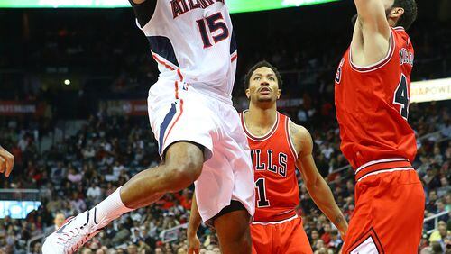 121514 ATLANTA: Hawks Al Horford grabs a rebound and goes to the basket for two points over Bulls defenders in a basketball game on Monday, Dec. 15, 2014, in Atlanta. CURTIS COMPTON / CCOMPTON@AJC.COM