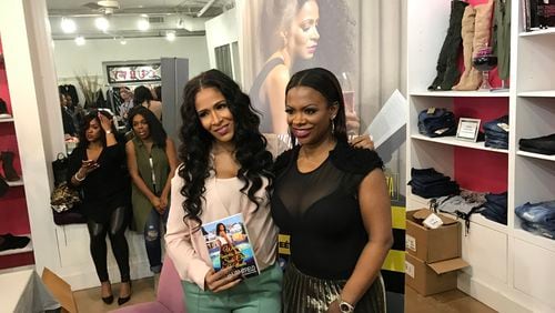 Sheree Whitfield and Kandi Burruss pose after her book signing at Kandi's TAGS Boutique in Buckhead March 5, 2017. CREDIT: Rodney Ho/ rho@ajc.com