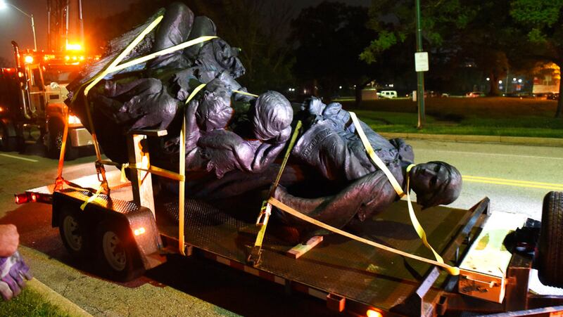 A monument dedicated to the Confederate Women of Maryland lies on a flatbed trailer early Wednesday, Aug. 16, 2017, after it was taken down in Baltimore. Local news outlets reported that workers hauled several monuments away early Wednesday, days after a white nationalist rally in Virginia turned deadly. (Jerry Jackson/The Baltimore Sun via AP)