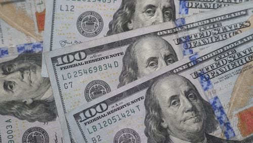 This Jan. 22, 2020, file photo shows the likeness of Benjamin Franklin on $100 bills. Many Americans are struggling financially due to the coronavirus. Recent federal efforts are aimed at easing credit for businesses and providing financial relief to Americans. (AP Photo/L.M. Otero, File)