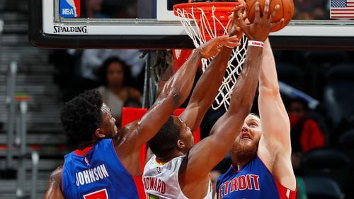 Stanley Johnson (7) and Aron Baynes (12) of the Pistons attempt to break up a pass to Dwight Howard (8) of the Hawks at Philips Arena on October 13, 2016 in Atlanta, Georgia. (Photo by Kevin C. Cox/Getty Images)