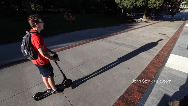 Jack Hearn, 20, a third-year civil engineering major at Georgia Tech, casts a long shadow from his scooter while on campus. With few clouds and little chance of rain, temperatures have reached the 90s. JOHN SPINK / JSPINK@AJC.COM