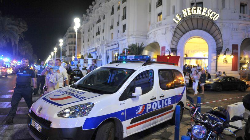 A police car is parked near the scene of an attack after a truck drove onto the sidewalk and plowed through a crowd of revelers who'd gathered to watch the fireworks. Five years ago in France, a man drove a truck through crowds celebrating Bastille Day along Nice’s beachfront, killing 86 and wounding more than 100. (AP Photo/Christian Alminana)