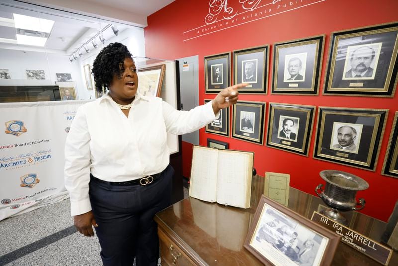 Atlanta Public Schools Superintendent Lisa Herring points to photographs of previous superintendents on display inside the APS Archive Museum at their downtown office as the APS commemorates its 150-year history. (Miguel Martinez / miguel.martinezjimenez@ajc.com)