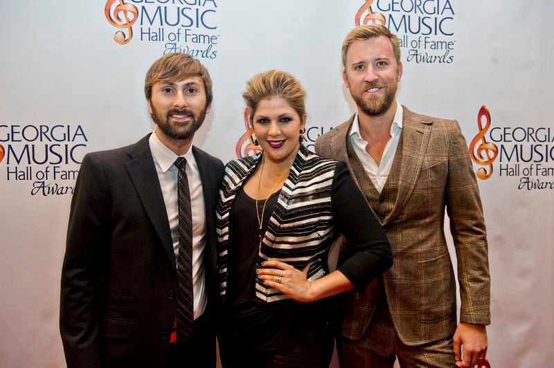 Dave Haywood (left), Hillary Scott and Charles Kelley from the band Lady Antebellum walk the red carpet for the 2014 Georgia Music Hall of Fame Awards at the Georgia World Congress Center in Atlanta on Saturday, October 11, 2014.     JONATHAN PHILLIPS / SPECIAL