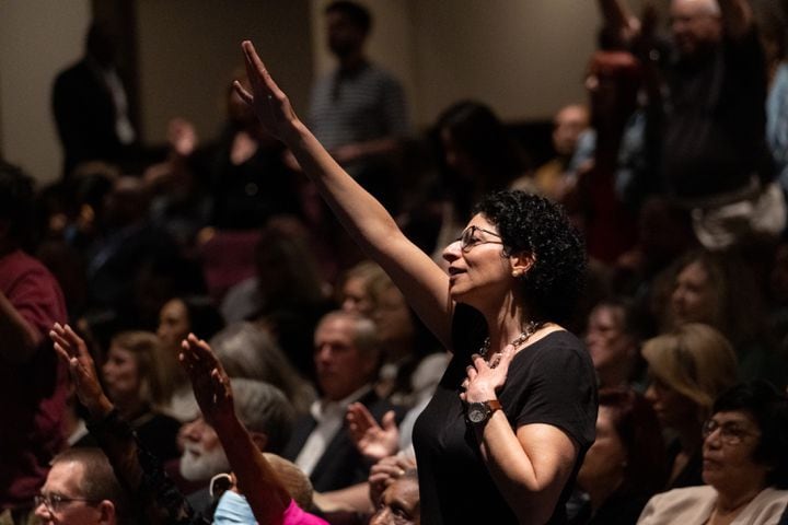 A woman stands with her arm outstretched while listening to CeCe Winans perform during the Legacy Celebration Service for the Rev. Charles F. Stanley at First Baptist Atlanta on Sunday, April 23, 2023. (Photo: Ben Gray for The Atlanta Journal-Constitution)
