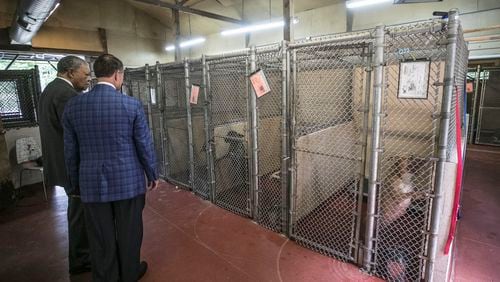 Fulton County Chairman Robb Pitts (left) and County Manager Dick Anderson get a tour of the Fulton County animal shelter last month. (Photo: Bob Andres / bandres@ajc.com)