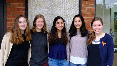 Walton High School walkout organizers include, from left, sophomore Natalie Carlomagno, senior Emma Fletcher, freshman Divya Virmani, junior Anisa Handa, and senior Madeleine Deisen. The students worked weeks in advance of Wednesday's walkout to organize classmates, meet with administrators, and spread their message calling for gun-law reforms. AJC/Vanessa McCray