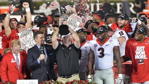 Georgia head coach Kirby Smart holds up the Rose Bowl trophy during the College Football Playoff Semifinal between Georgia and Oklahoma at Rose Bowl Stadium in Pasadena, Calif., on Jan. 1. The championship game against Alabama Monday could be a traffic headache for downtown Atlanta. HYOSUB SHIN / HSHIN@AJC.COM