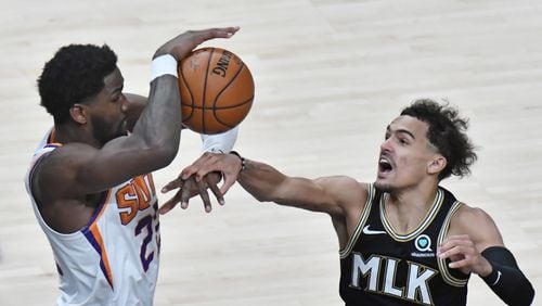 Hawks guard Trae Young (right) fights for a rebound with Phoenix Suns center Deandre Ayton (22) at State Farm Arena on Wednesday, May 5, 2021. The Hawks won 135-103 over Phoenix Suns. (Hyosub Shin / Hyosub.Shin@ajc.com)