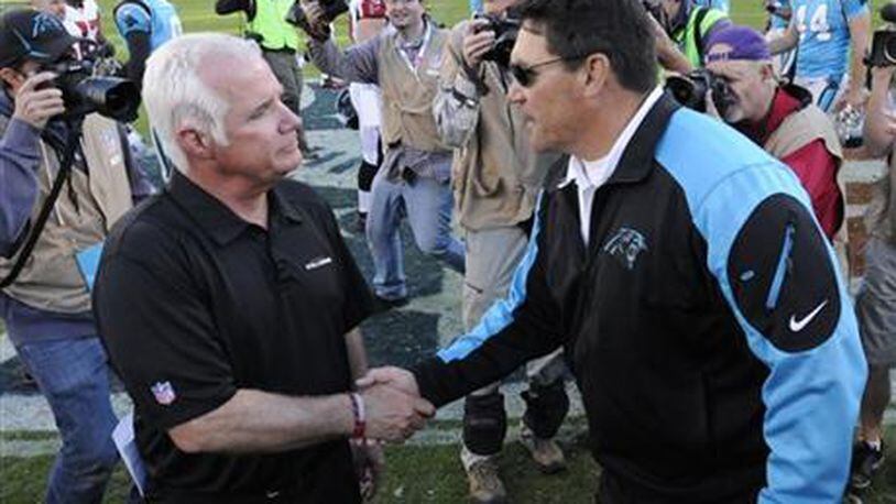 Carolina Panthers head coach Ron Rivera, right, shakes hands with Atlanta Falcons head coach Mike Smith after an NFL football game in Charlotte, N.C., Sunday, Nov. 3, 2013. The Panthers won 34-10. (AP Photo/Mike McCarn)