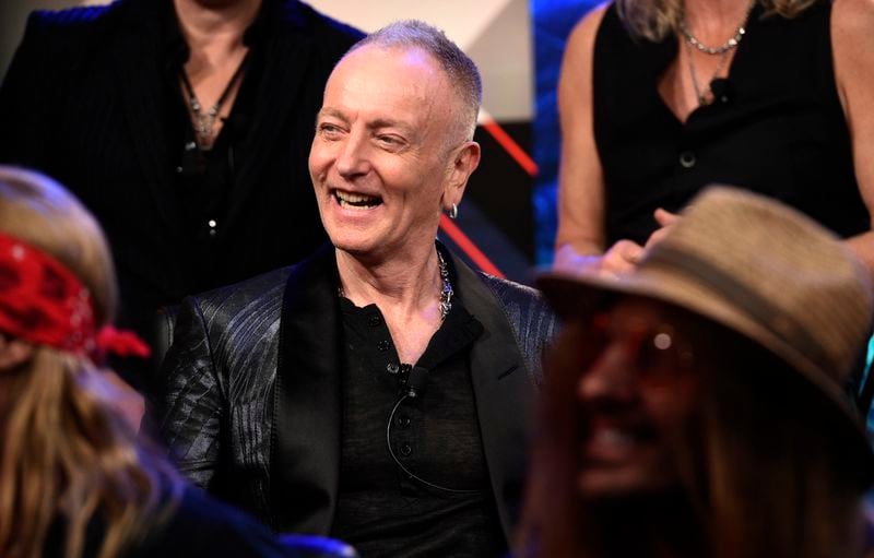 Phil Collen of Def Leppard laughs during a news conference to announce The Stadium Tour 2020 featuring Def Leppard, Poison and Motley Crue, at the SiriusXM offices, Wednesday, Dec. 4, 2019, in Los Angeles. (AP Photo/Chris Pizzello)
