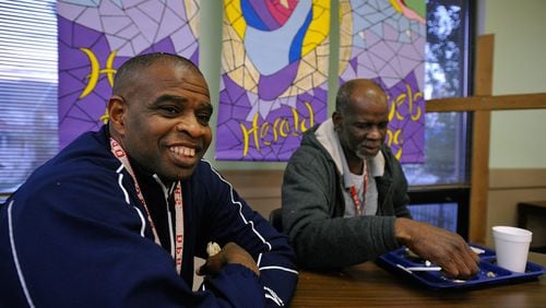 Homeless veterans Mike Adams, left, and Robert Turman finish dinner at the Salvation Army’s Luckie Street location. Adams, an Army veteran, struggled with drug and alcohol addiction and homelessness for years after leaving the service. Adams also works at the Salvation Army’s homeless shelter and is hoping to find a career, maybe in web design. Turman is a mechanic. DAVID TULIS / AJC SPECIAL