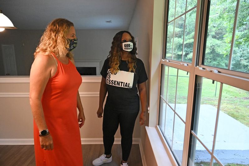 August 21, 2020 Lithonia - Jacki Gould (left) and her client Monica Nash walk through the house, which there were a multiple offers and it is now under contract to Monica Nash, in Lithonia on Friday, August 21, 2020. Story is about the enthusiastic homebuyers, despite the pandemic. (Hyosub Shin / Hyosub.Shin@ajc.com)