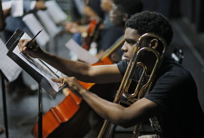 Corey Jones Jr., a student from Charles R. Drew Charter School, makes some notes on his music as he gets ready for rehearsal. He’s one of the teen musicians from the Atlanta Music Project who will perform with T.I. at a NPR Music live concert on July 12. BOB ANDRES /BANDRES@AJC.COM