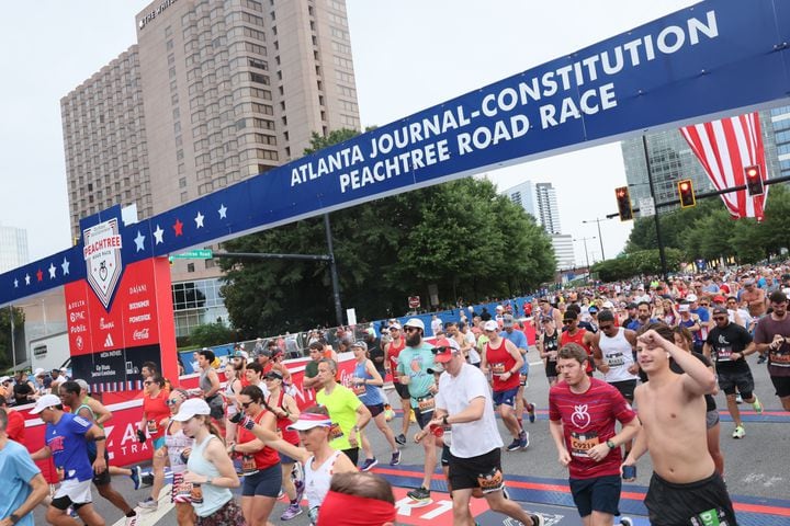 Runners take off at the start of the 54th running of the Atlanta Journal-Constitution Peachtree Road Race in Atlanta on Tuesday, July 4, 2023.   (Arvin Temkar / Arvin.Temkar@ajc.com)