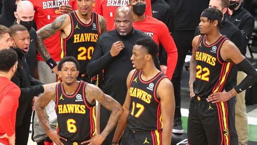 Hawks interim head coach Nate McMillan and Lou Williams (from left), John Collins, Onyeka Okongwu, and Cam Reddish look for answers during a time out against the Milwaukee Bucks during the third quarter in game 5 of the NBA Eastern Conference Finals on Thursday, July 1, 2021, in Milwaukee.   “Curtis Compton / Curtis.Compton@ajc.com”
