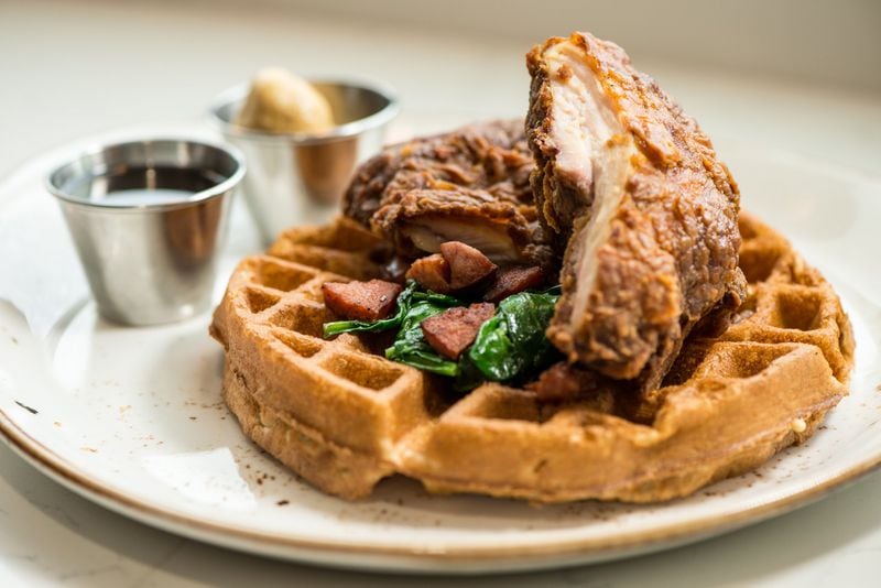 Luda’s Chicken and Pecan Waffles with whiskey maple syrup, spinach and andouille sausage. Credit: Mia Yakel.