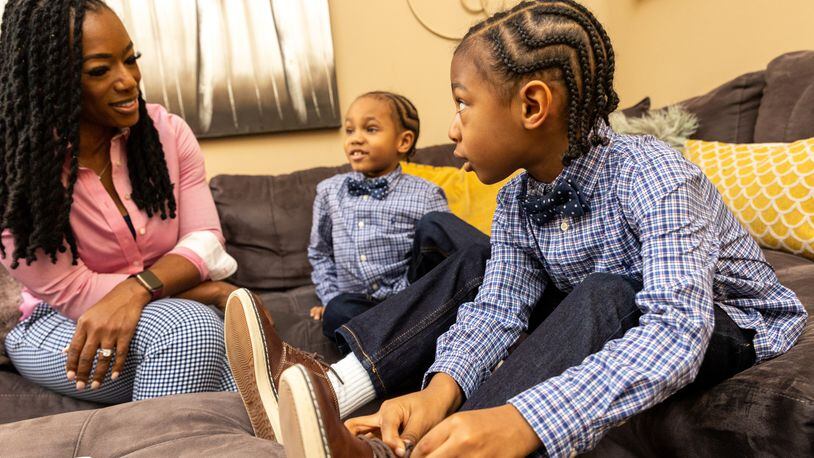 Shea Guillory with her 6-year-old twins Sawyer, left, and Saxton, right. Sawyer was born with sickle cell disease. A doctor transplanted some of Saxton's bone marrow into Sawyer to treat the disease, which disproportionately affects African Americans.  (Jenni Girtman for The Atlanta Journal-Constitution)