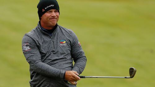 All warm and cozy, Scott McCarron enjoys a shot on No. 18 at TPC Sugarloaf Saturday. (Photo by Kevin C. Cox/Getty Images)