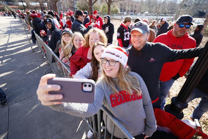 Jennifer Neal takes a selfie with Mike Neal, Bri Neal, Donna Foster, Karly Foster, and Macy foster as they wait at the Dawg Walk or the team to arrive at the Dawg Walk during the victory parade in Athens on Saturday, January 14, 2023. Miguel Martinez / miguel.martinezjimenez@ajc.com
