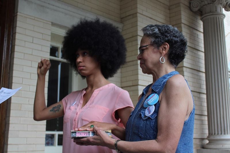 On Monday, the 26-year-old University of Georgia doctoral student and her towering Angela Davis afro — was sworn in as an Athens-Clarke County Commissioner. When she took her oath of office, she was didn t use a bible. On the steps of the Athens City Hall, Parker cocked her right fist in the air and place her left hand on a well-worn copy of “The Autobiography of Malcolm X,” held by her mother Mattie Parker. Probate Judge Susan Tate swore her in as the District 2 commissioner. “They asked if they would like the Bible and I said no. My mother asked if there was a copy of the Constitution around. No, Parker said. I wanted Malcolm s book. I think they saw it coming.” Photo courtesy Raphaëla Alemán.