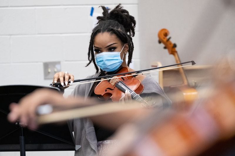 211208-Lawrenceville-Kimiya Drane tunes her violin during class at the new Gwinnett School of the Arts in Lawrenceville on Wednesday, Dec. 8, 2021. Ben Gray for the Atlanta Journal-Constitution